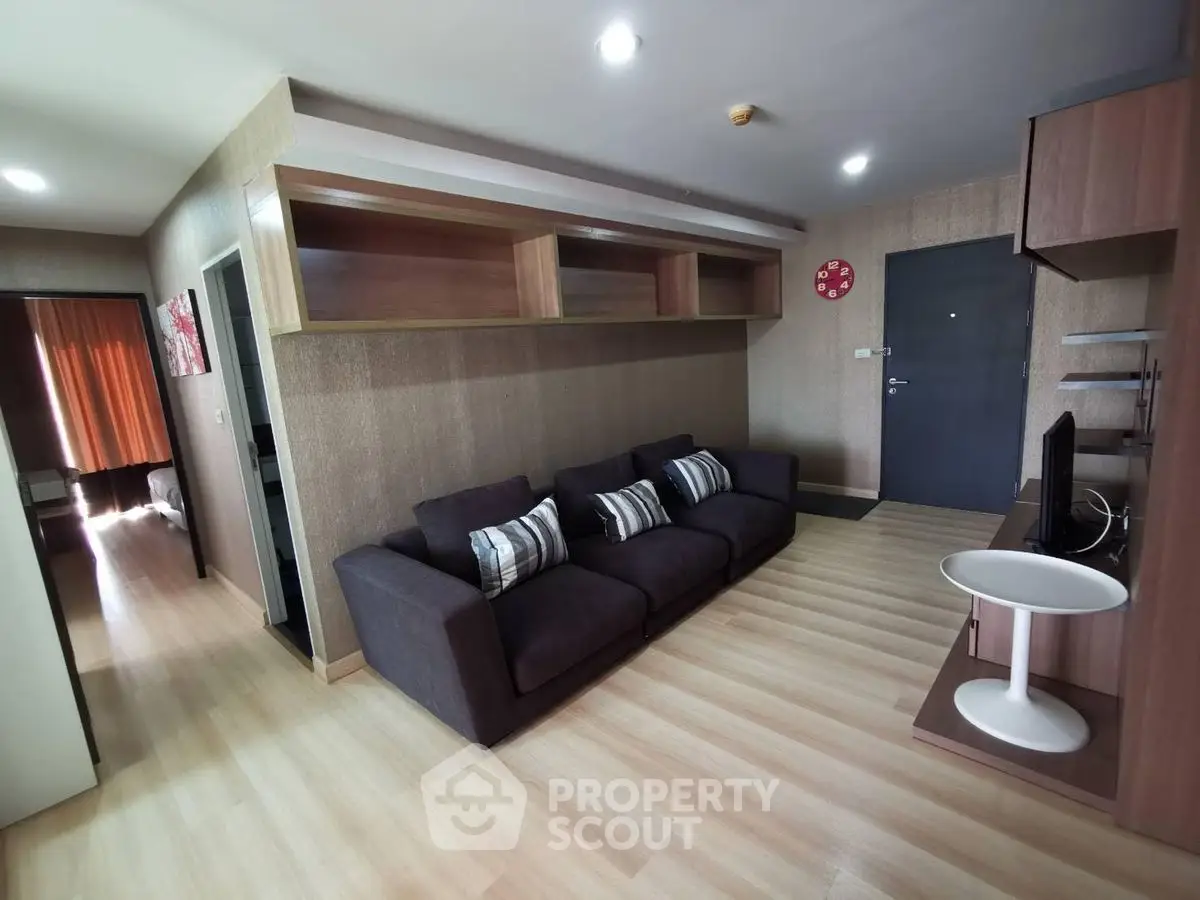 Modern living room with stylish sofa and open shelving, perfect for cozy gatherings.
