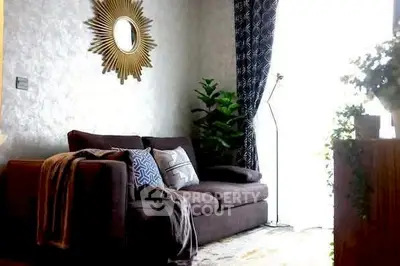 Cozy living room with stylish sofa and decorative mirror