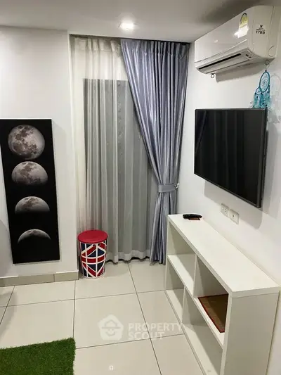 Modern living room with sleek decor, wall-mounted TV, and stylish moon phase artwork.