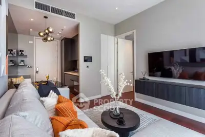 Modern living room with stylish decor, wall-mounted TV, and cozy seating area.