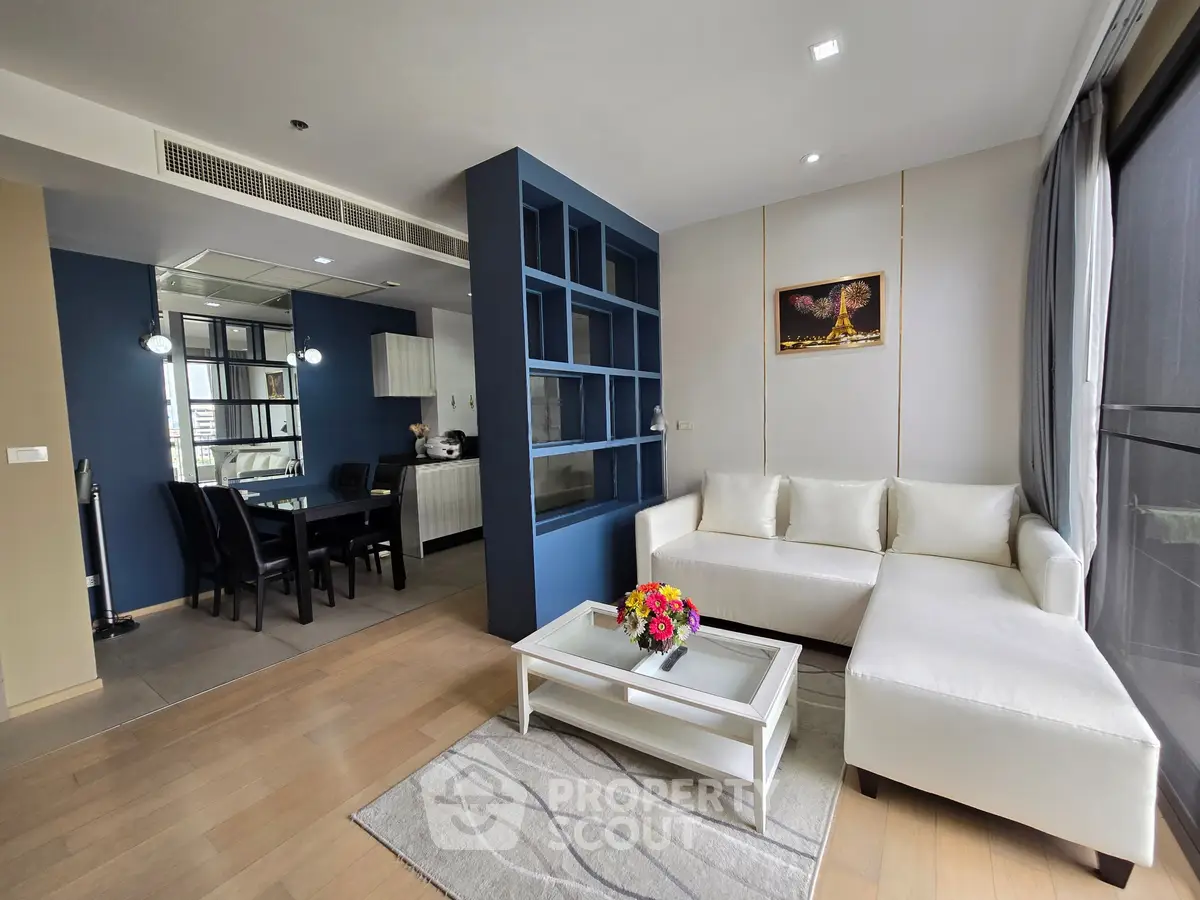 Modern living room with white sectional sofa and open kitchen layout