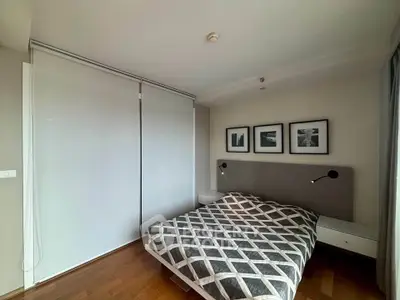 Modern bedroom with stylish decor and wooden flooring