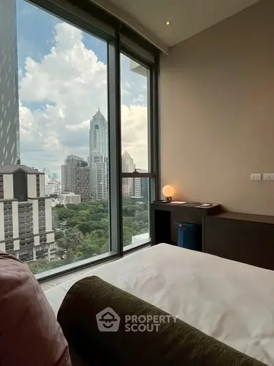 Luxurious bedroom with stunning city view from floor-to-ceiling windows.
