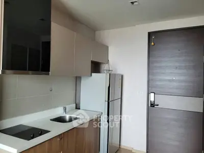 Modern kitchen with sleek cabinetry and built-in appliances in a compact layout.