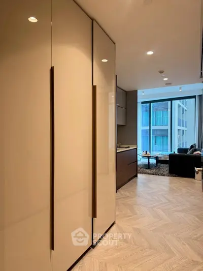 Modern living room with sleek design and large windows offering natural light.