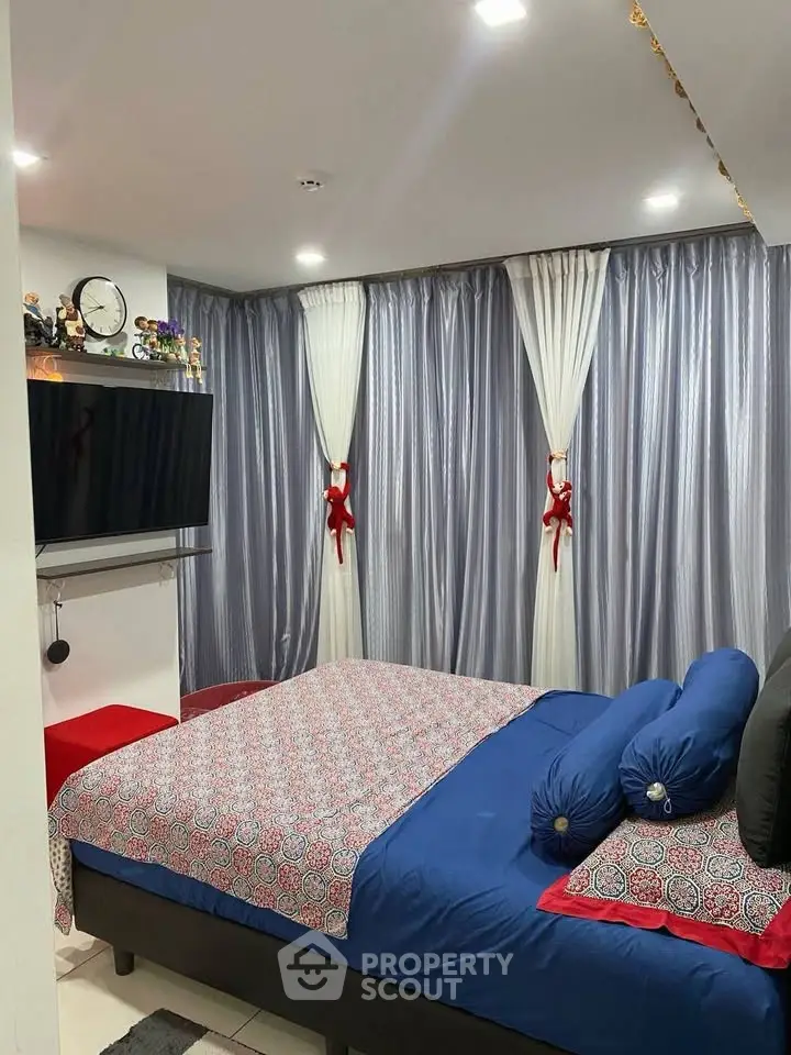 Cozy bedroom with stylish decor and modern TV setup