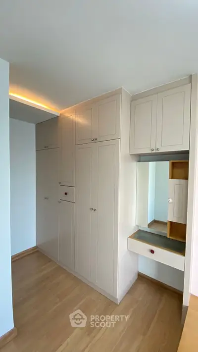 Spacious built-in wardrobe with sleek design and ample storage space