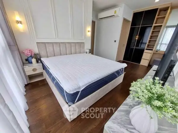 Spacious bedroom with modern decor and ample natural light