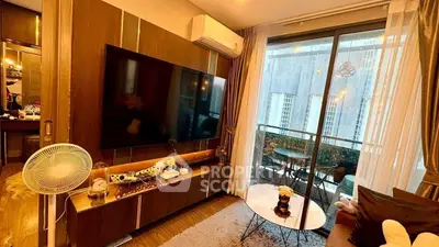 Modern living room with large TV and balcony view in high-rise apartment