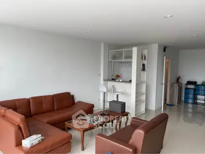 Spacious living room with modern furniture and open layout, perfect for relaxation and entertainment.