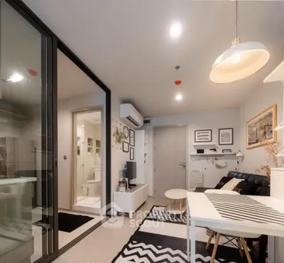 Modern living room with stylish decor and open layout, featuring a cozy seating area and contemporary lighting.