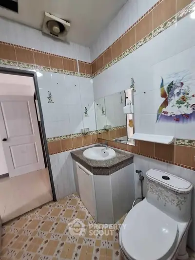 Charming bathroom with unique tile design and modern fixtures, perfect for a cozy home.