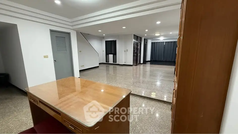 Spacious open-plan living area with glossy floors and modern design