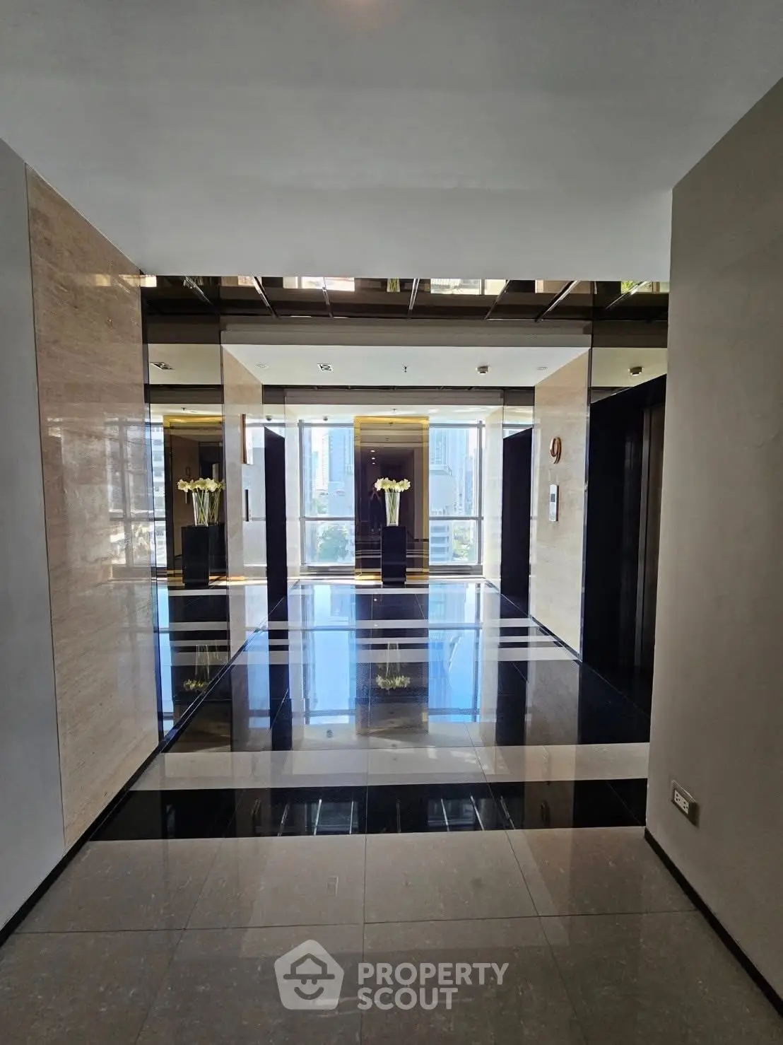 Luxurious modern elevator lobby with sleek design and polished floors.