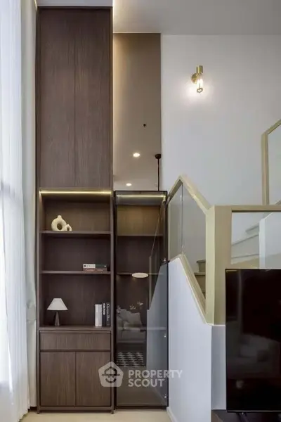 Modern interior with sleek wooden shelving and elegant staircase design