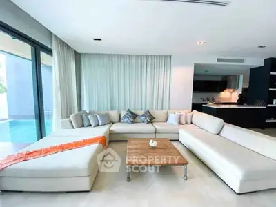 Luxurious modern living room with pool view and elegant furnishings