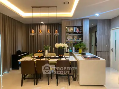 Modern dining area with elegant lighting and open kitchen design