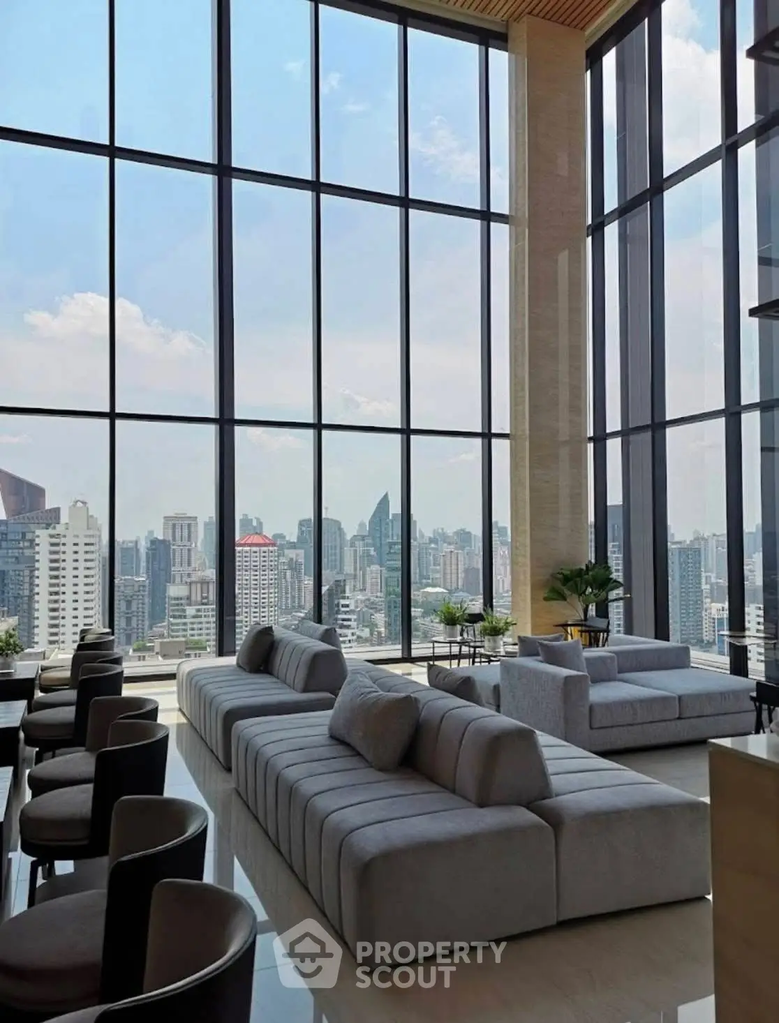 Luxurious high-rise living room with panoramic city views and modern furnishings.