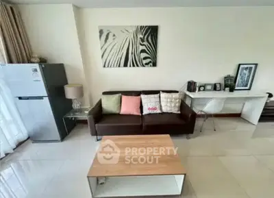 Modern living room with stylish decor and sleek furniture, featuring a cozy sofa and contemporary artwork.