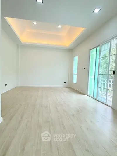 Spacious modern living room with wooden flooring and recessed lighting