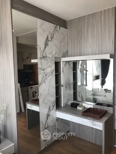 Modern bedroom with stylish marble accents and built-in vanity mirror