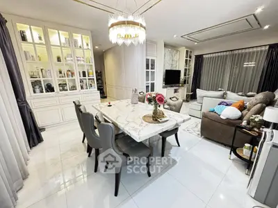 Luxurious open-plan living and dining area with elegant marble table and modern decor.