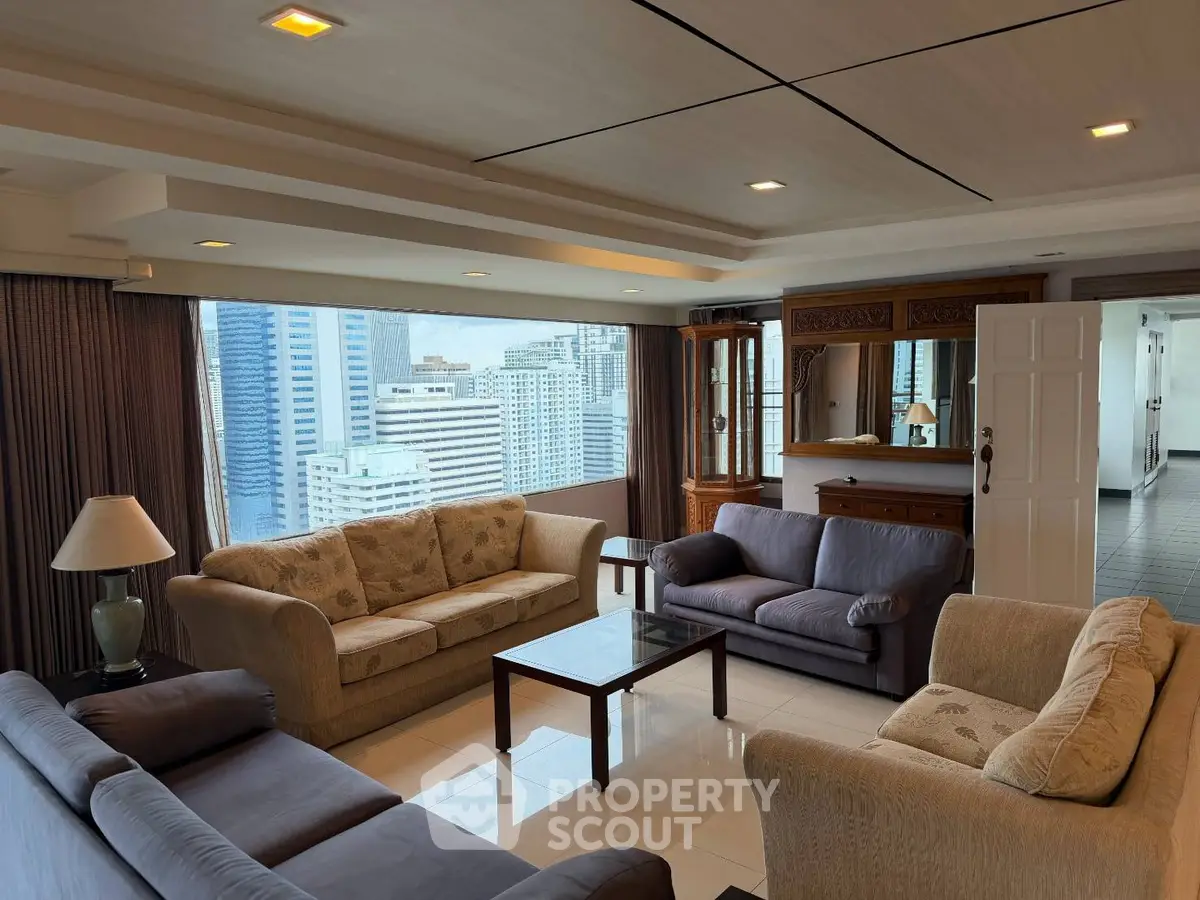 Spacious living room with city view, featuring elegant sofas and modern decor in a high-rise apartment.