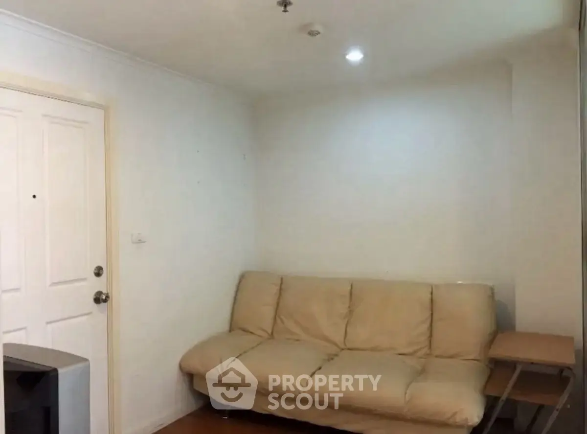 Cozy living room with beige sofa and wooden side table