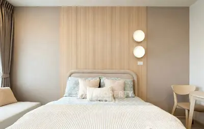 Modern bedroom with stylish decor and cozy bedding in a contemporary apartment.