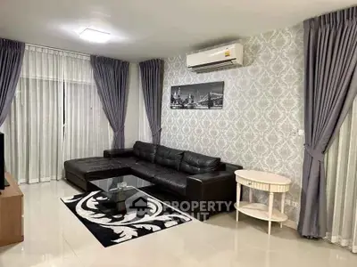 Modern living room with stylish decor and leather sofa in a cozy apartment.