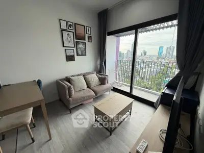 Modern living room with balcony and city view, featuring stylish decor and natural light.