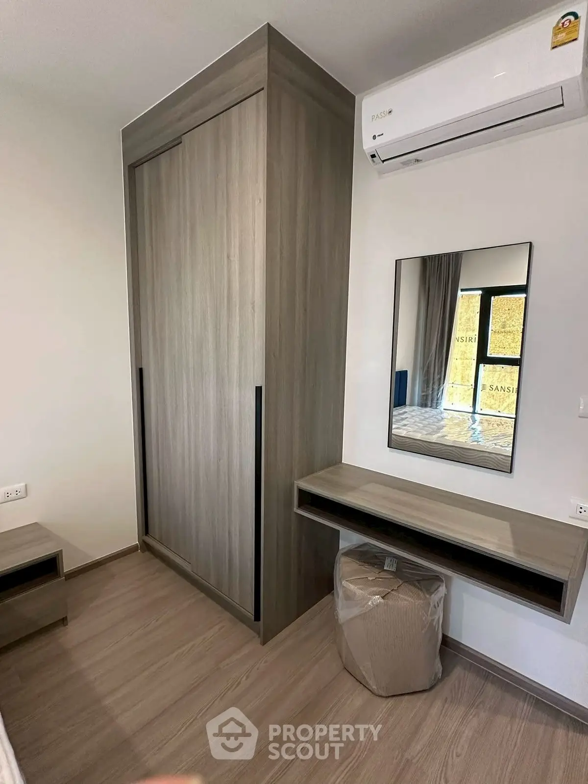 Modern bedroom with sleek wardrobe and air conditioning unit