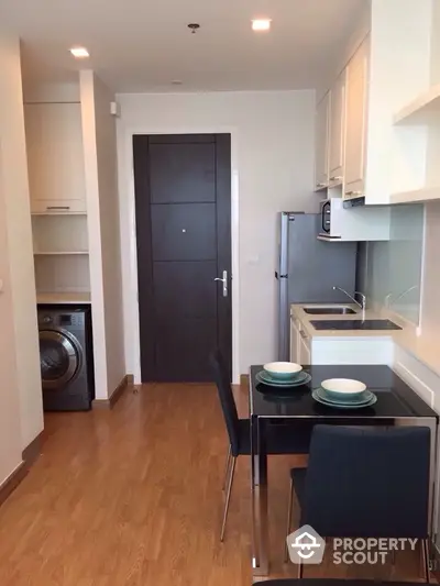 Modern apartment kitchen with dining area and washing machine