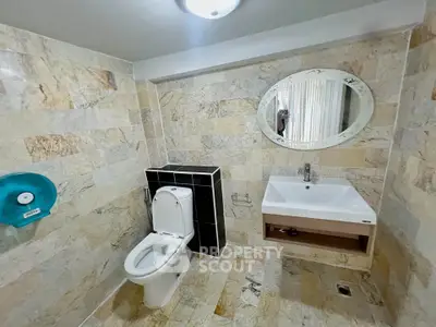 Modern bathroom with elegant stone tiles and stylish fixtures