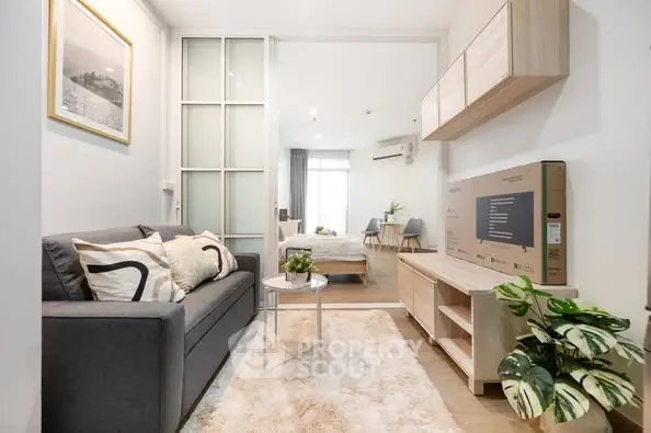 Modern living room with cozy decor and stylish furniture in open layout apartment.