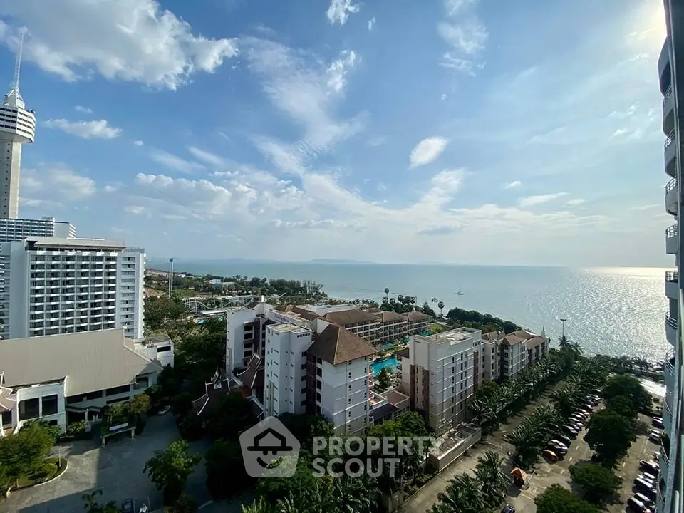Stunning ocean view from high-rise building balcony in coastal cityscape.