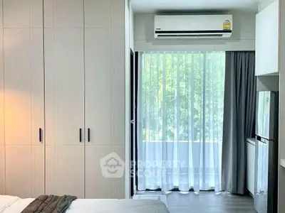 Modern bedroom with built-in wardrobe and balcony view