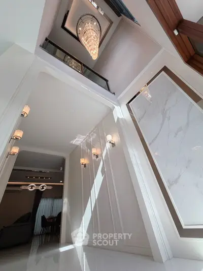 Luxurious modern interior with high ceilings and elegant chandelier