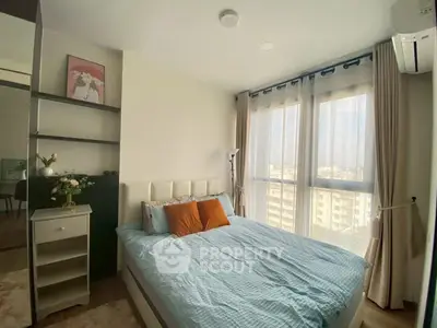 Cozy bedroom with large windows and modern decor in a high-rise apartment