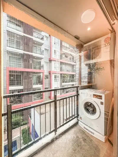 Modern apartment balcony with washing machine and city view
