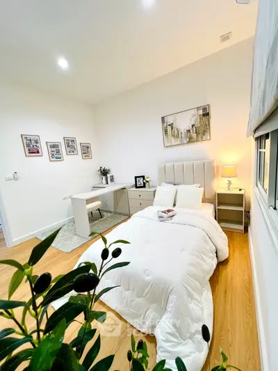 Elegant bedroom with modern decor, cozy bedding, and stylish artwork, perfect for relaxation and comfort.