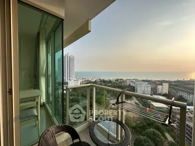 Stunning balcony view with ocean and cityscape, perfect for relaxation and enjoying sunsets.
