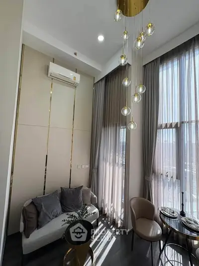 Luxurious high-ceiling living room with elegant lighting and modern decor
