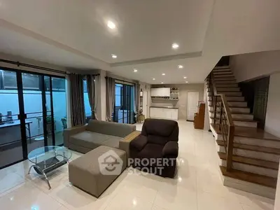 Spacious modern living room with open layout and stylish staircase