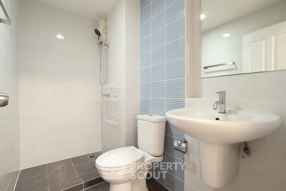 Modern bathroom with sleek fixtures and a spacious shower area