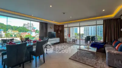 Spacious living room with large balcony and city view, perfect for entertaining.