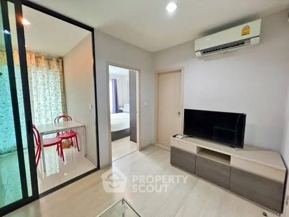 Modern living room with TV and air conditioning in stylish apartment