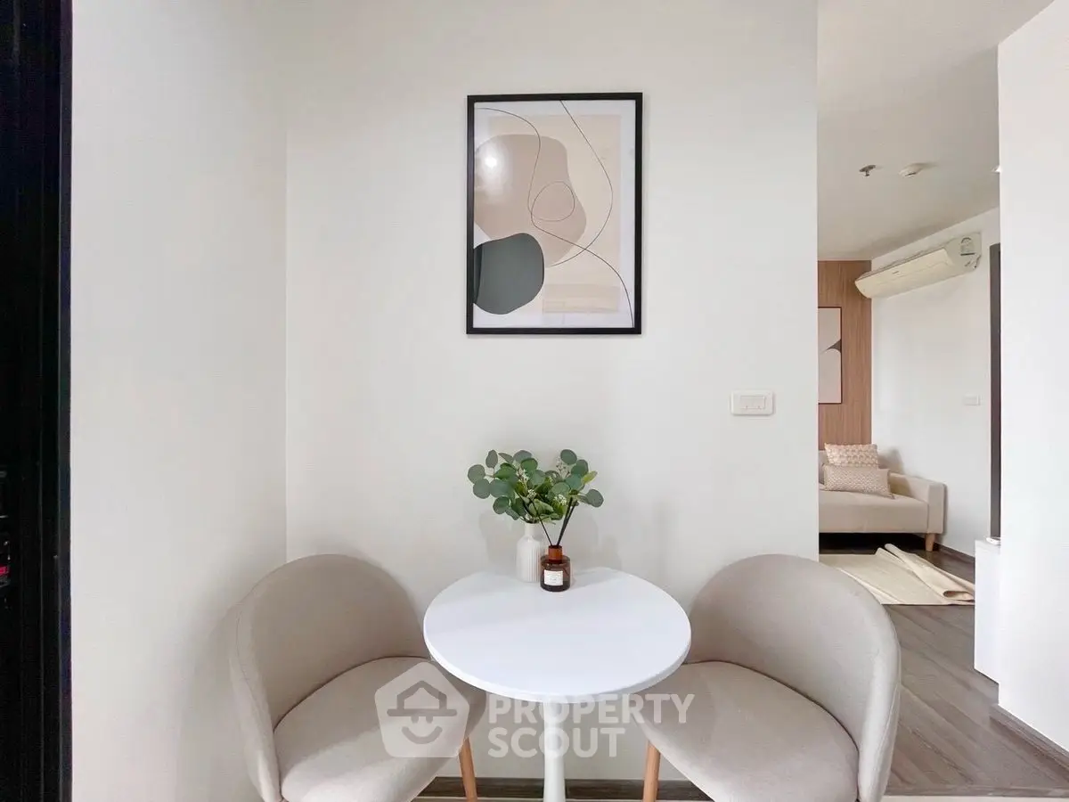 Cozy modern nook with round table and chairs, perfect for intimate gatherings.