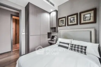 Modern bedroom with stylish decor and built-in storage in a luxury apartment.