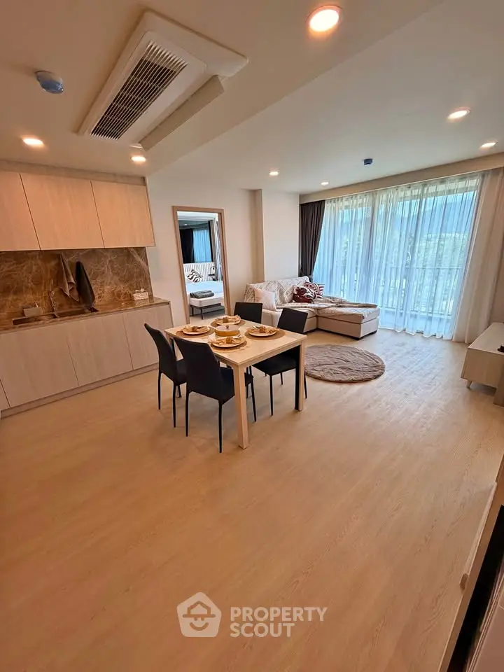 Spacious open-plan living room with modern kitchen and elegant dining area